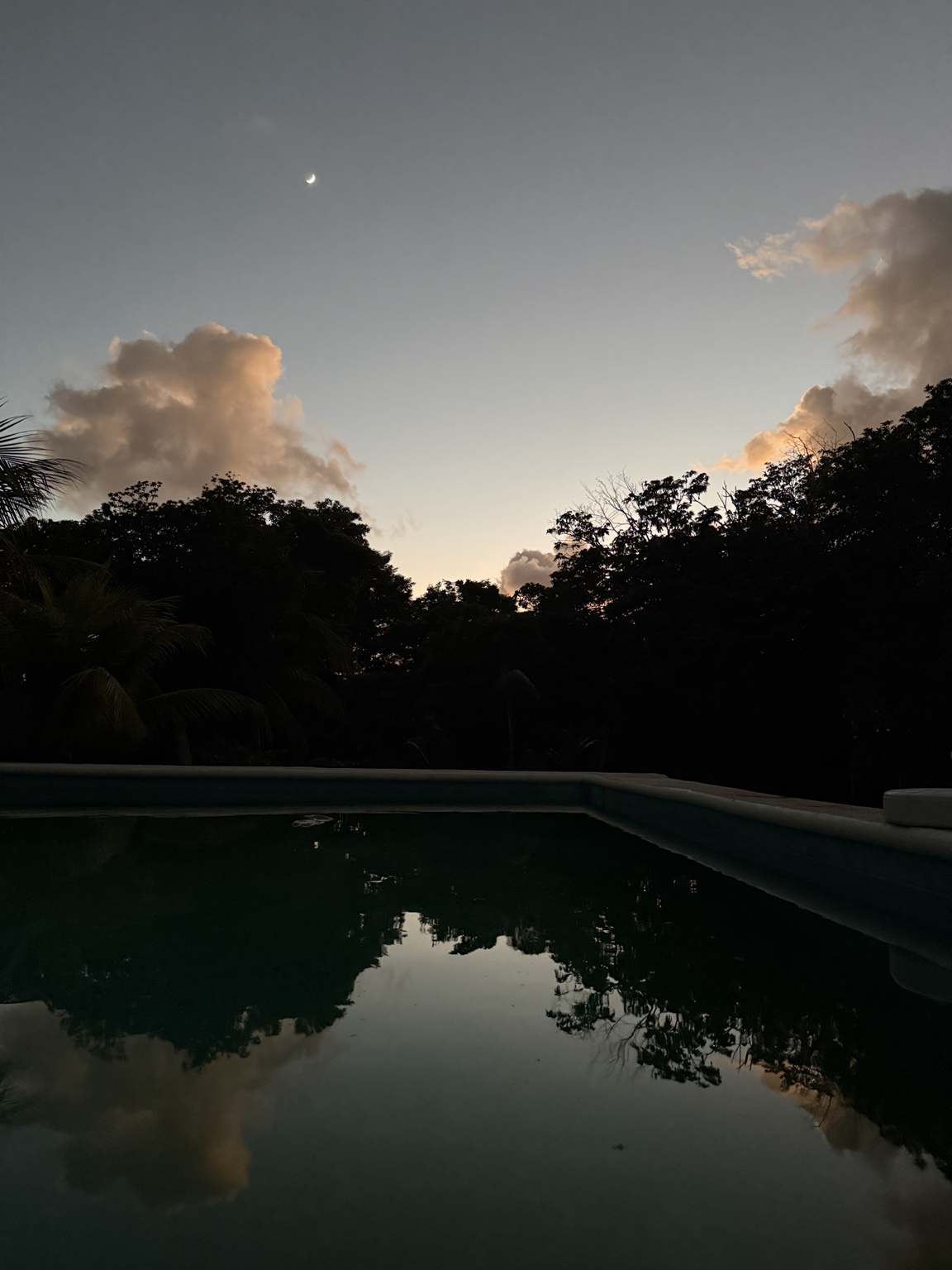 Pool at Aluxes Jungle Sanctuary at sunset.